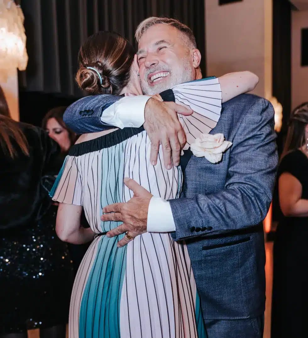 Two delegates embracing at Amour