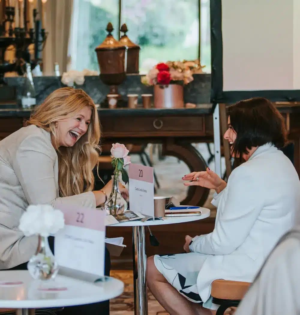 Two delegates in conversation at an Amour meeting table